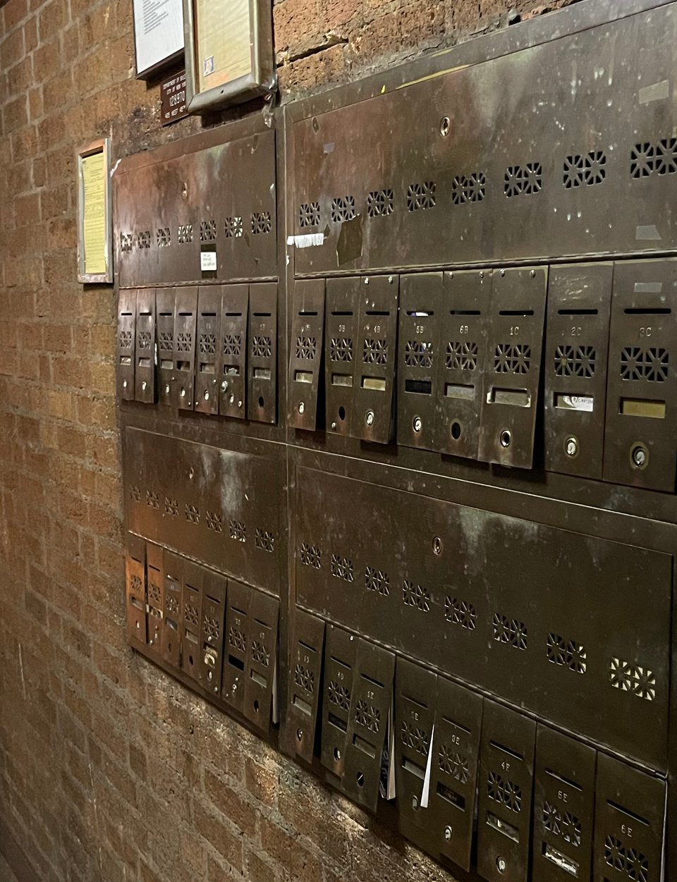 Crooked old brass mailboxes