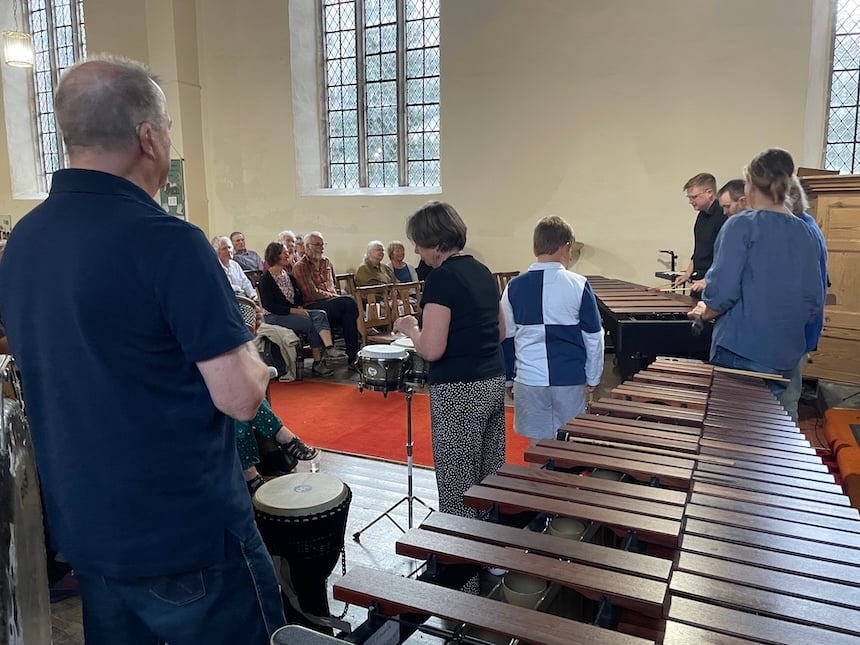 Audience members play with an ensemble