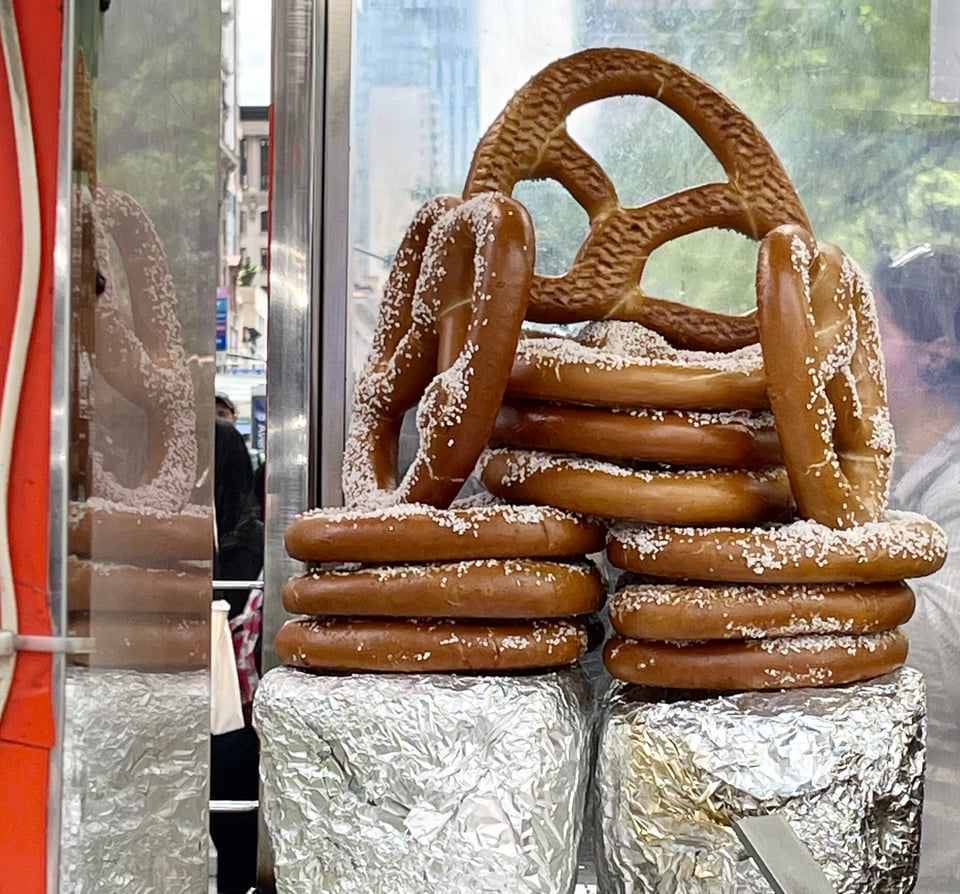 Stack of fat pretzels being sold from a street cart.