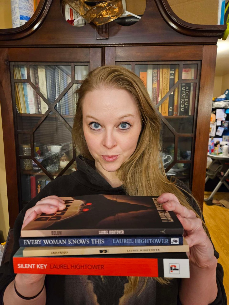 laurel hightower holding four of her books
