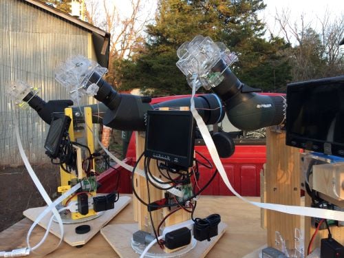 a row of spotting scopes fitted with video cameras
