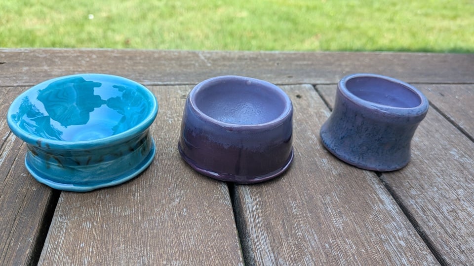 the three bowls again, with the finished fired glaze. One is turquoise, one is lavender and plum, and the third is lavender and a mottled, subdued green-ish blue.
