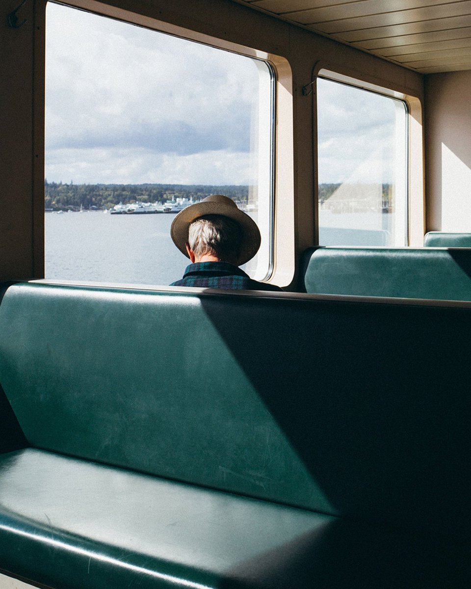 A photograph of a man riding on a ferry