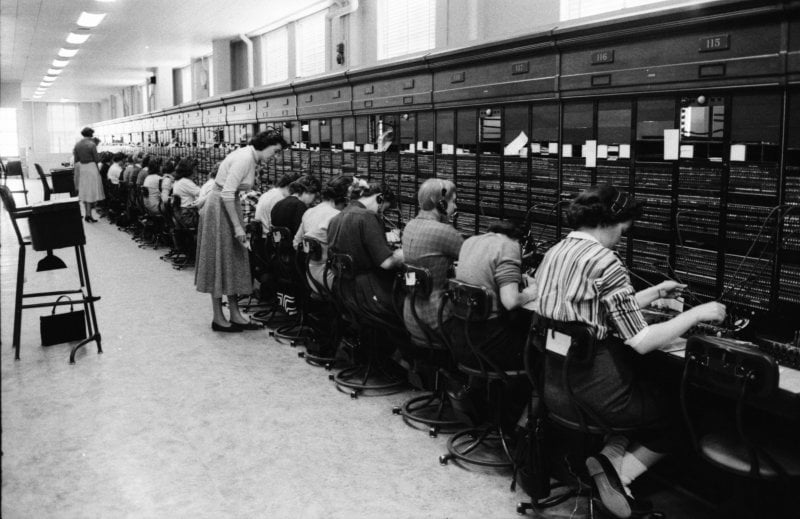 Dozens of phone operators in a old B&W photo