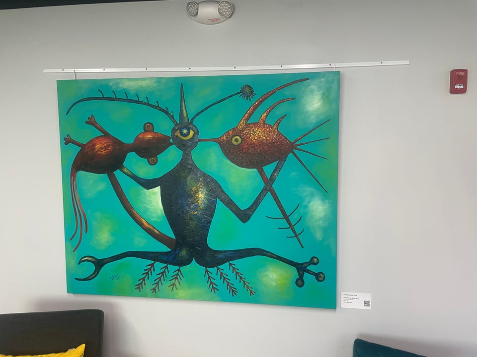 A strange painting of 3 alien like creatures on a blue background