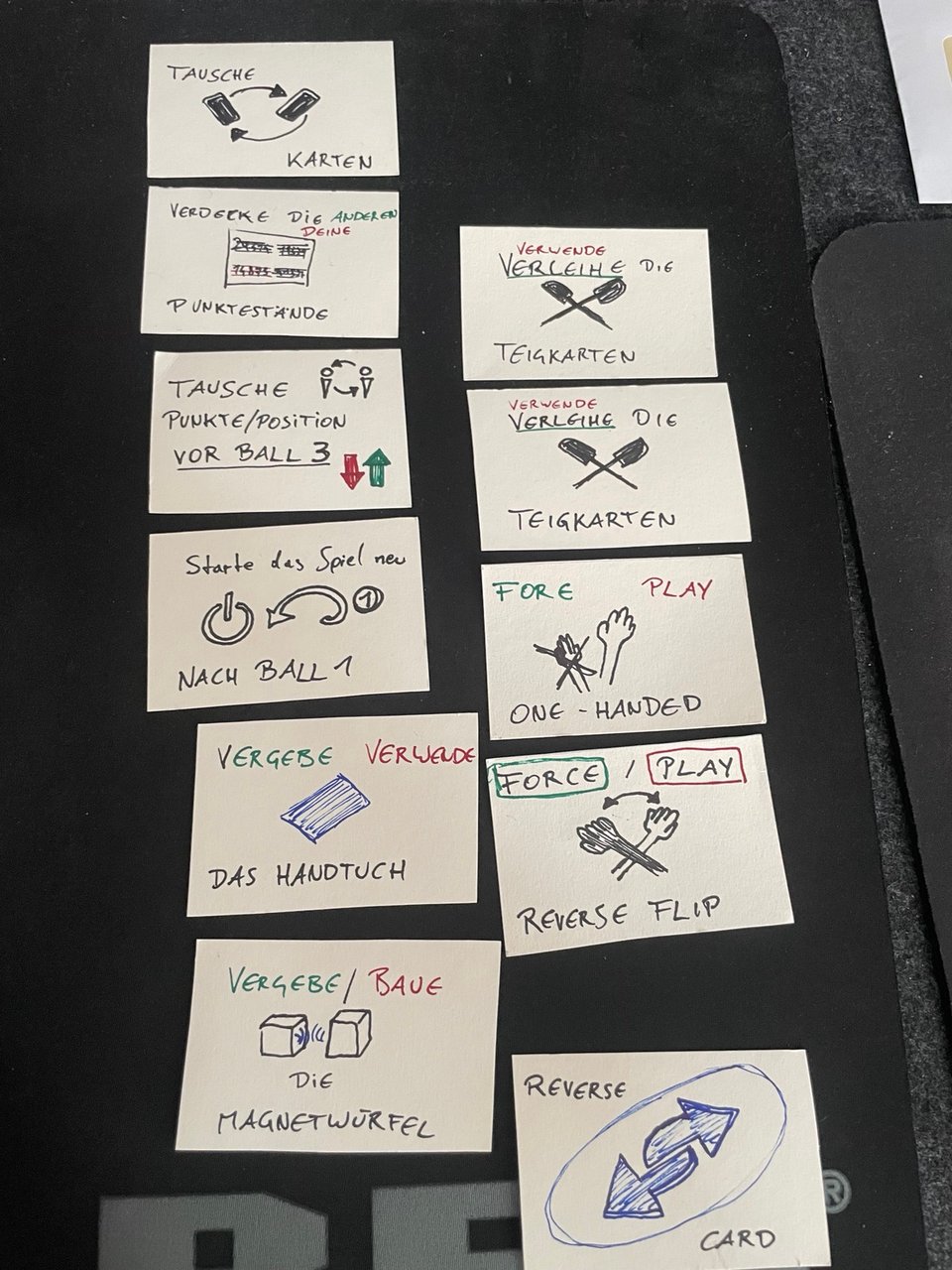 Self-made cards with certain debuffs and anti-perks on them to alleviate different skill levels during pinball play.