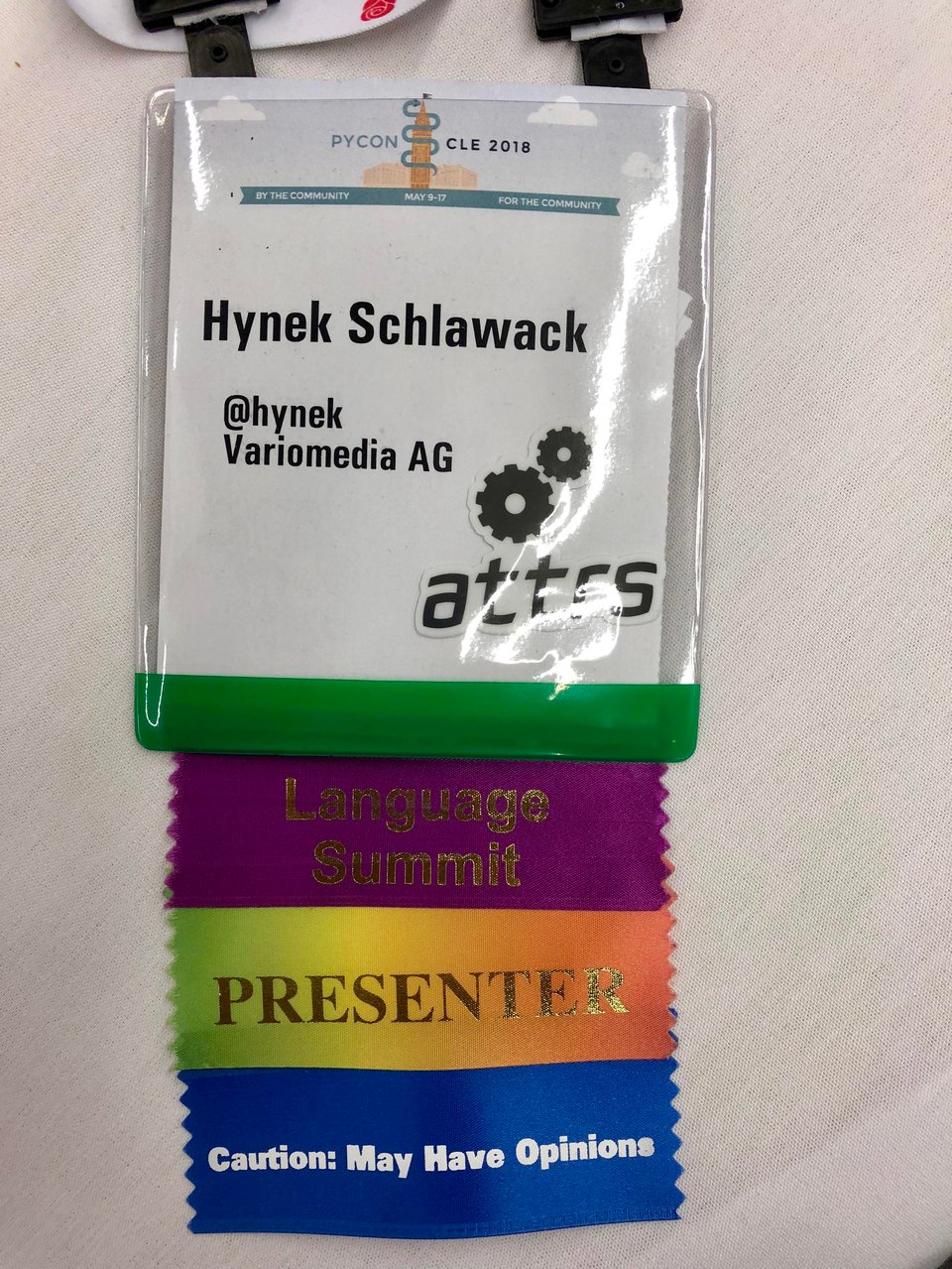My badge from PyCon US 2018 with a "Caution: May Have Opinions" ribbon.