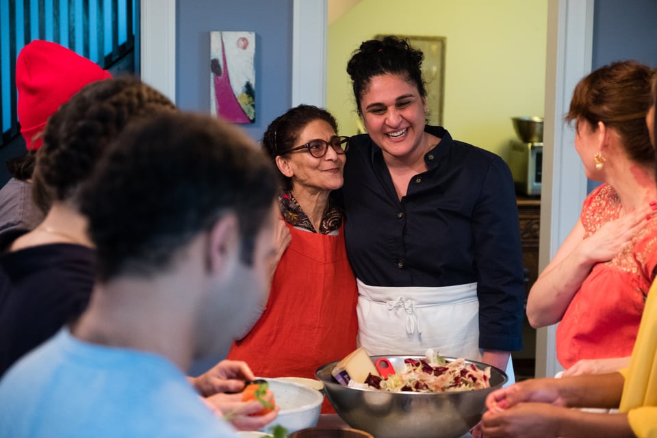 a group of people in a kitchen, smiling