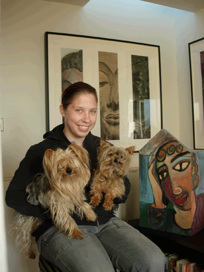 Photo of Anna, a white nonbinary person, holding Yorkies Winston and Frank