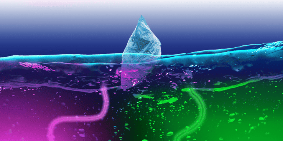 An iceberg in water that glows with neon strands.