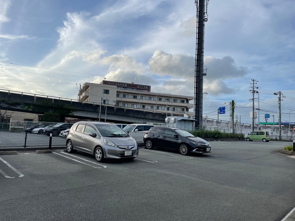 The parking lot of the writer's apartment. The car on the left, a silver Honda Fit, is the writer's new ride.