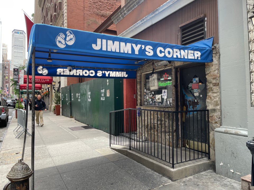 The blue awning in front of an old boxing bar.
