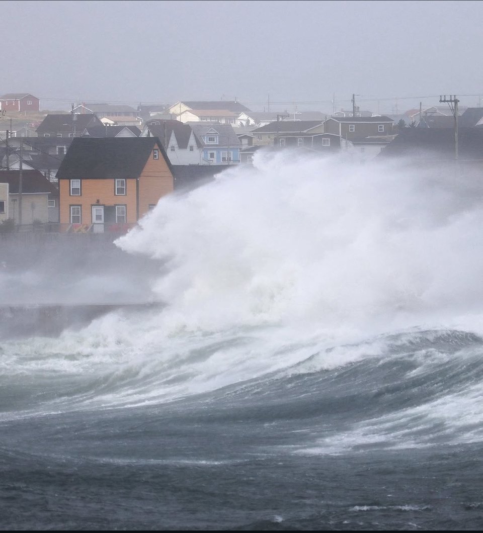 Huge waves crashing along the shoreline on a grey day in picturesque Bonavista, Newfoundland.