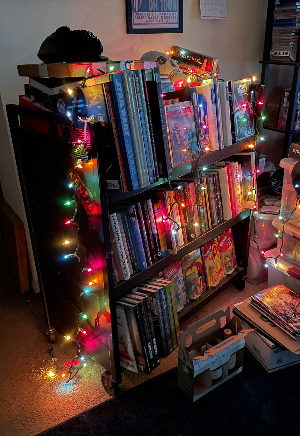 A book cart in a living room covered with a haphazard string of lights