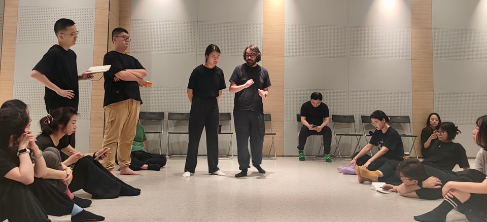 a group of people sitting in a circle listening the facilitator