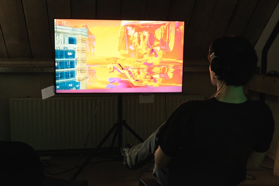A person plays a videogame on a screen