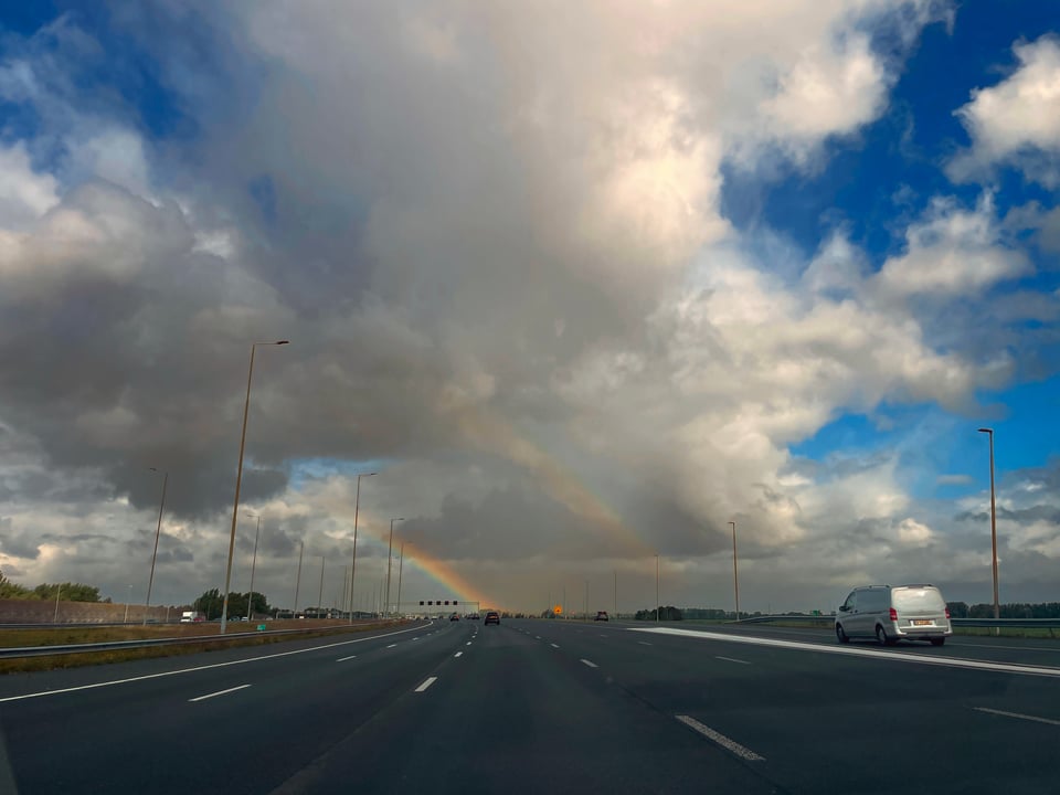 A double rainbow over a freeway.