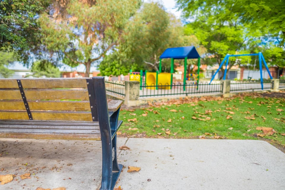 Image of Duncan Reserve showing a park bench and some play equipment.