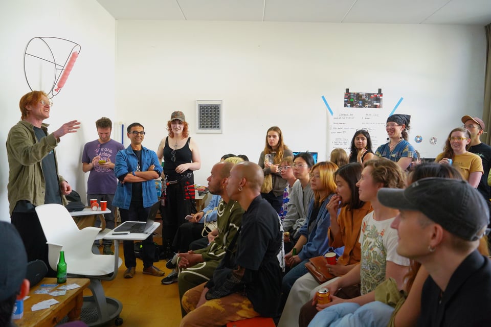 A host gestures at the audience