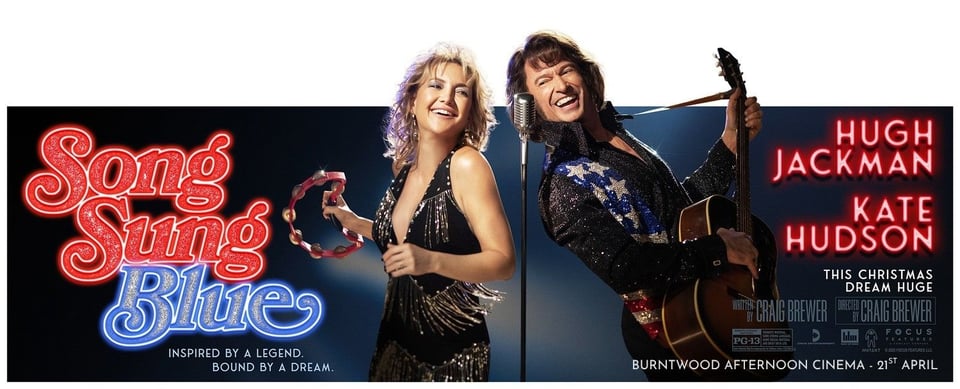Promotional poster for Song Sung Blue. Kate Hudson and Hugh Jackman grin at the camera against a dark stage backdrop — she holds a tambourine, he holds a guitar. Text reads: "Inspired by a legend. Bound by a dream. Hugh Jackman. Kate Hudson. Burntwood Afternoon Cinema – 21st April.