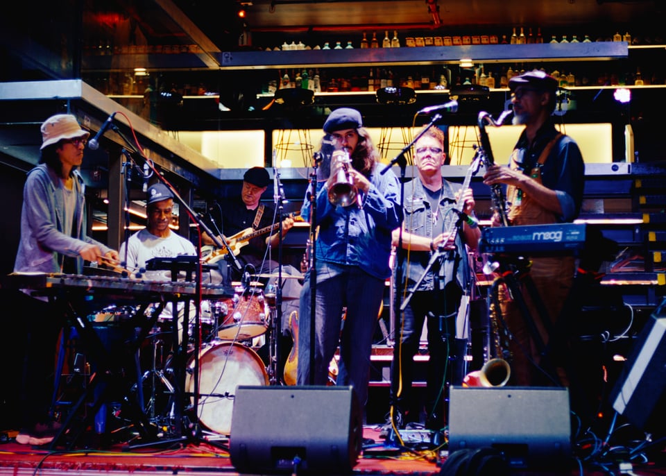 Six musicians on stage. Left to Right: Yusuke Yamamoto vibraphone, Chris Eddleton drums, Bruno Coon Bass, Vincent Curson Smith trumpet, Blake Leyh electric cello, Tony Jarvis bass clarinet