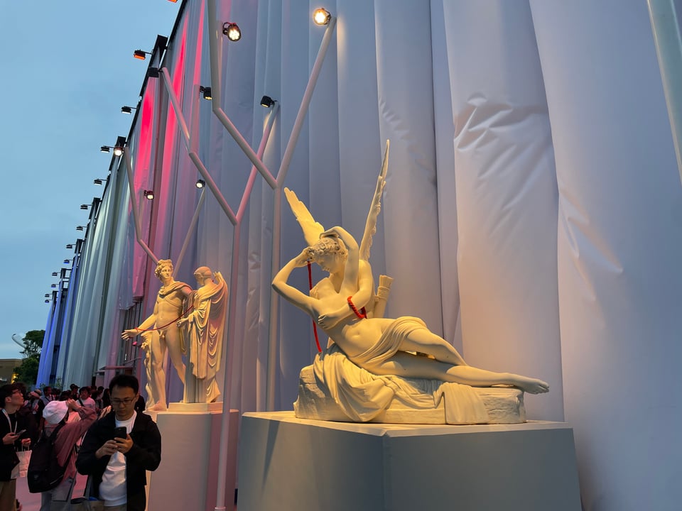 Another angle of Cupid and Psyche, with red rope draped over them. Apollo and Venus are in the background.