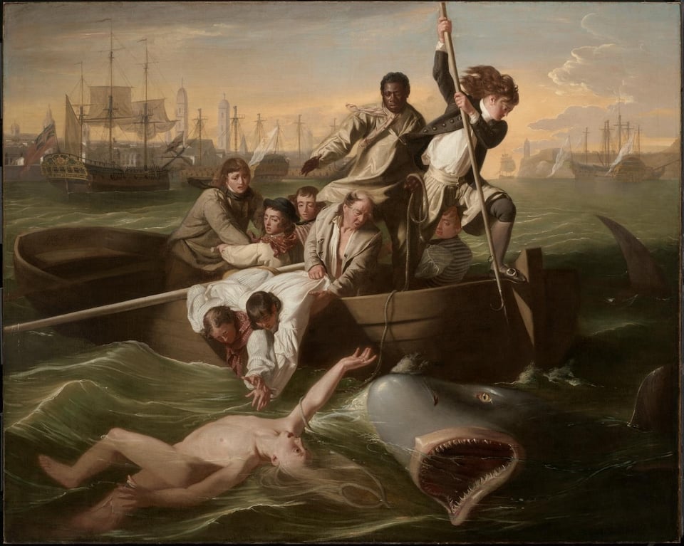 In the bay, a rowboat with eight men in it try to rescue a boy who has fallen into the sea and is about to be attacked by a large shark. One man thrusts a spear toward the shark.