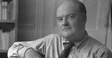 A black and white photo of Edmund Wilson in his office