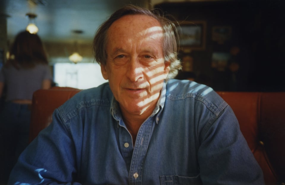 Playwright Andre Gregory seated in a diner.