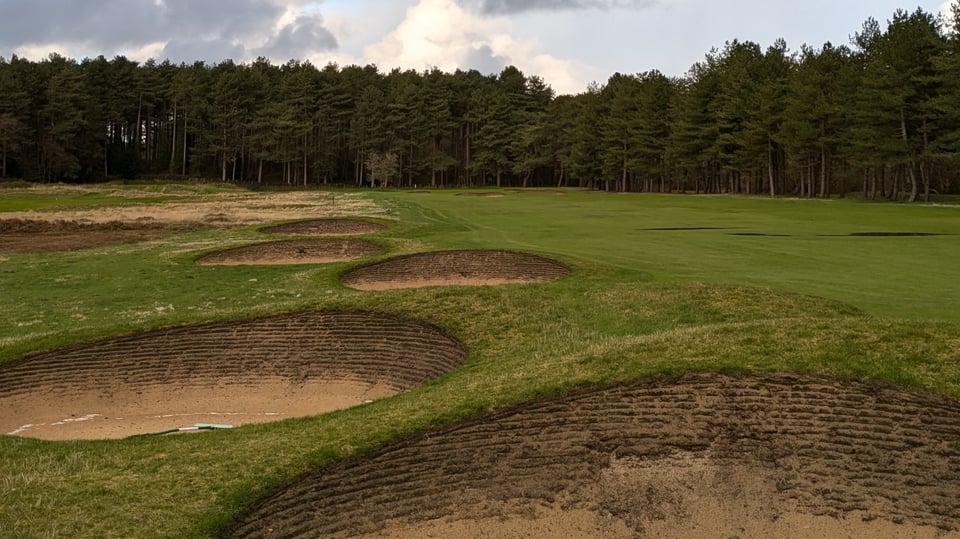 Formby 3rd, par 5 fairway with some standing water, large bunkers littered down the left, more large bunkers protecting the front of the green in the distance, temporary green short left