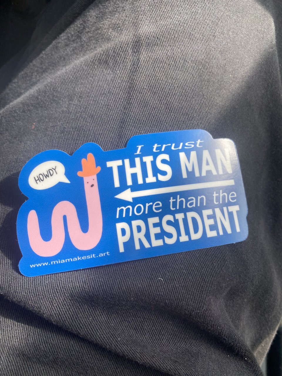 sticker that has a worm and says ‘I trust this man more than the president"