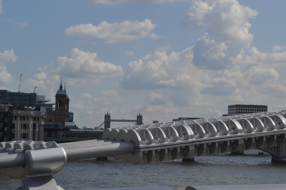 A view of the Thames, with Tower Bridge in the background. In the foreground is a bridge cable.