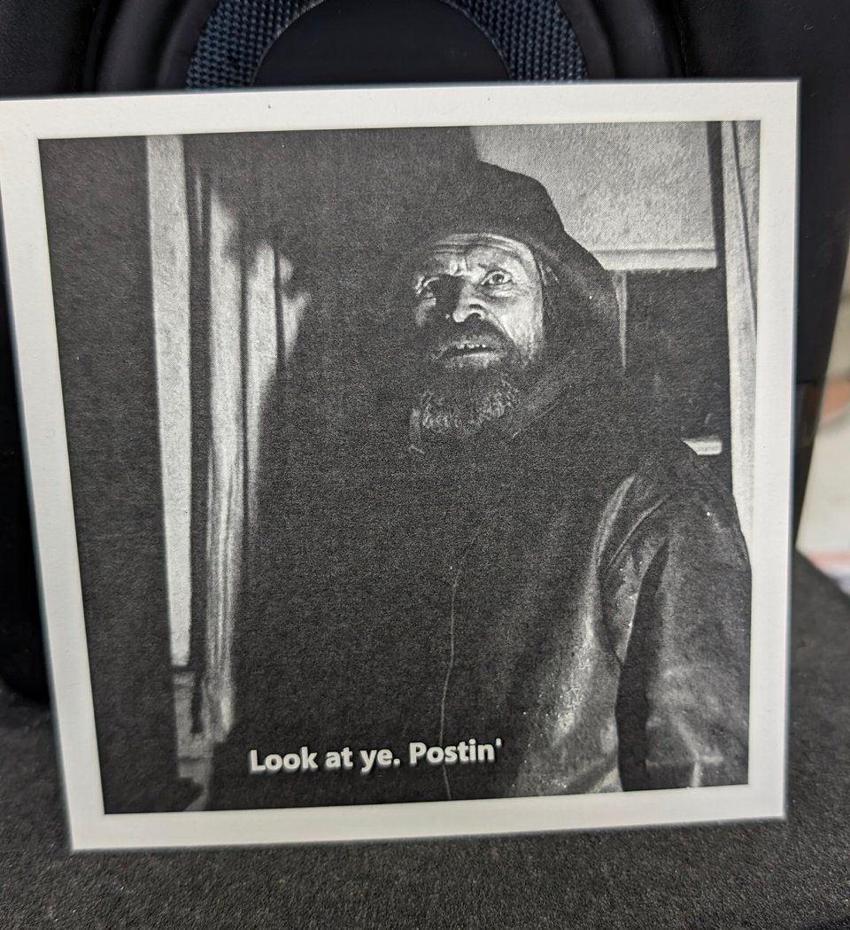 A picture of a frame from The Lighthouse with Willem Dafoe's character saying "Look at ye. Postin'"