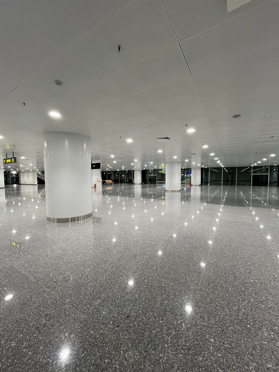 empty floor with bright flights and pillars but nothing else