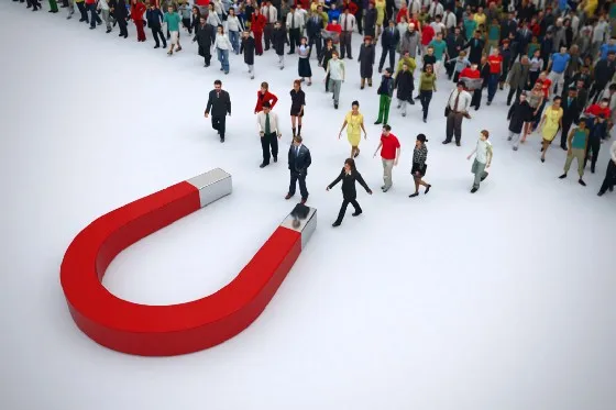 a group of people standing around a magnet
