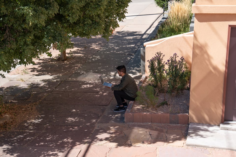 A man sitting outside on a video call.