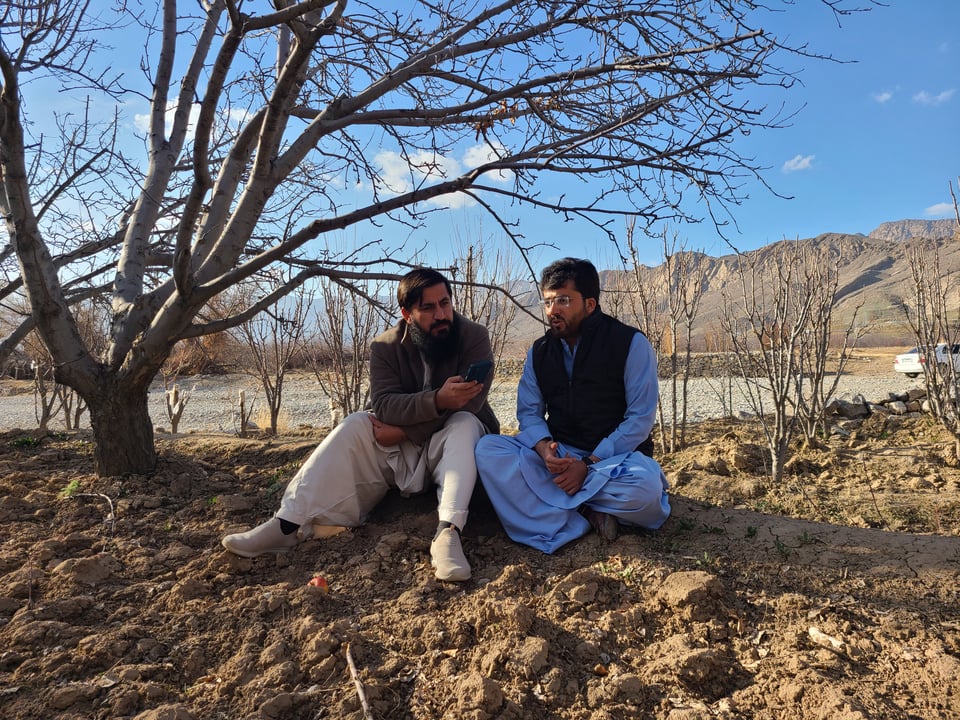 Mahboob Khan, a Pakistani farmer, details the hardships faced in the bitter cold to a reporter, while sitting under a dry tree.