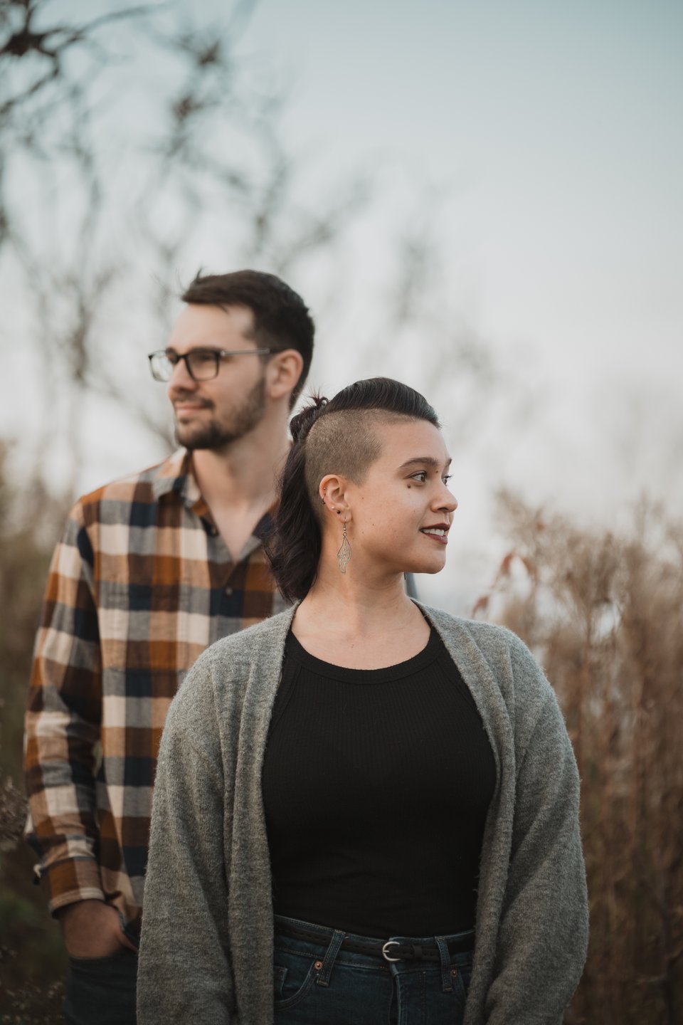an artistic shot of a couple looking in opposite directions