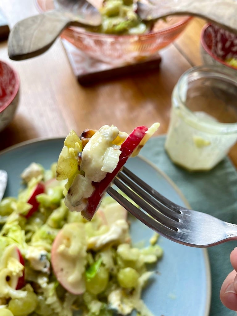 A fork with all the components of a waldorf salad on it