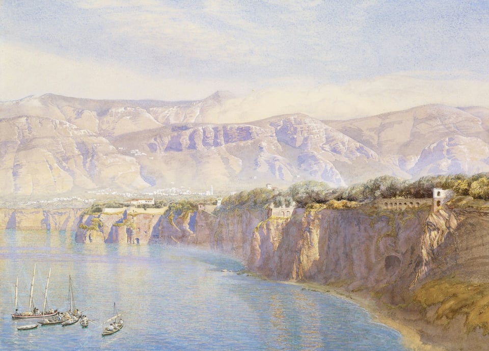 A cliff and boats stationed near it