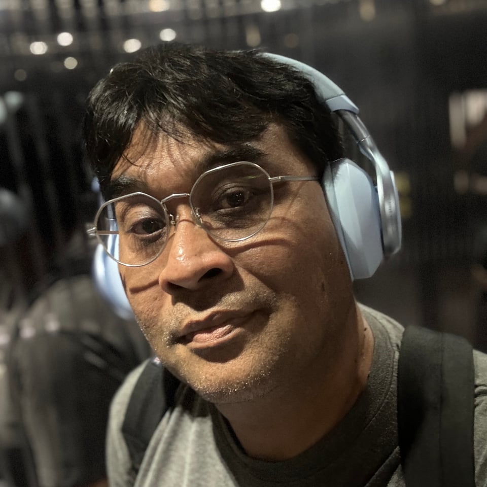 me wearing large pair of light blue headphones