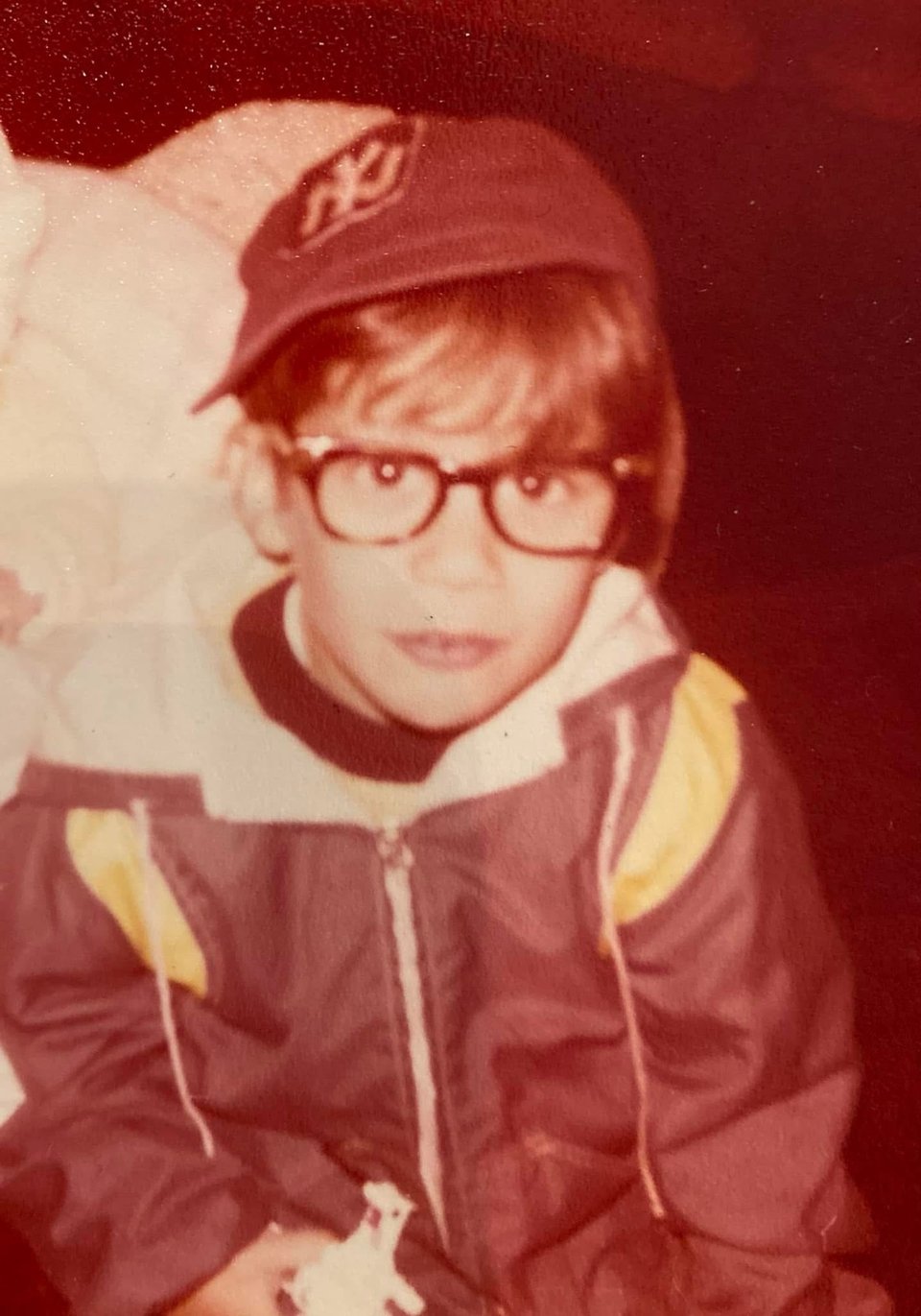 lil Neil Kleid, circa 1979, wearing glasses and a ny yankees cap