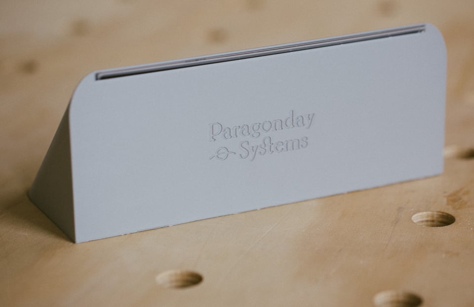 A silver device with Pragonday Systems debossed on the back.