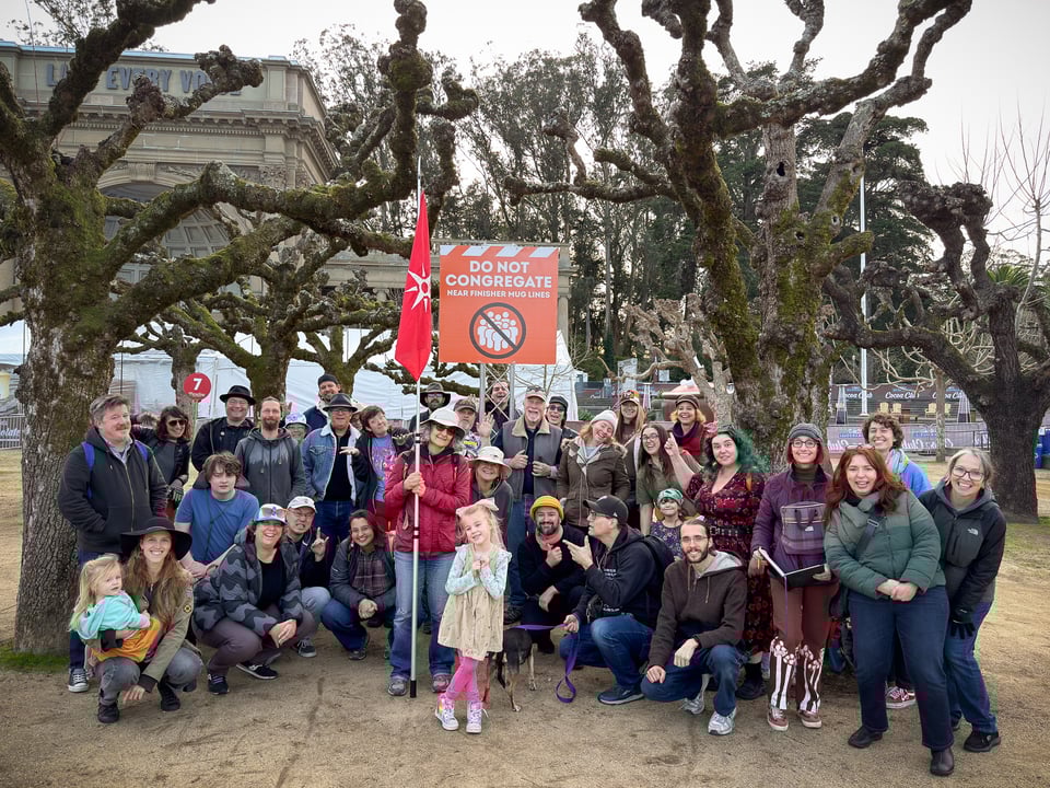 Explorers standing in front of a "Do Not Congregate" sign