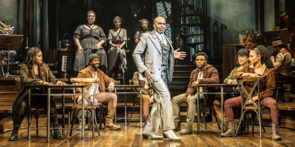 The cast of Hadestown on stage.