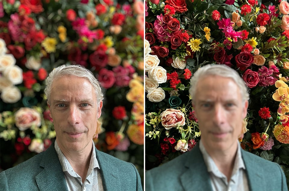 portrait-mode selfie of white man in green dress jacket with wall of flowers in the background, out of focus, and same but with the flowers in focus and the man's face out of focus