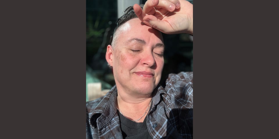 the author sitting in the sun, eyes closed