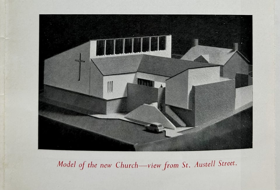 A page in a leaflet showing a photo of a model of the new church. It is made up of white blocks on top of a granite plinth, with a staircase on the street and a large monopitch roof.