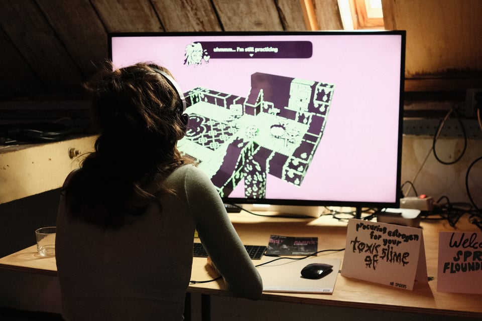 A person plays a videogame on a screen