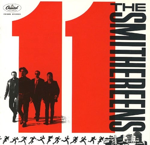 A giant red "11" takes up most of the cover. Superimposed on the first 1 are the band, four white guys walking. Along the bottom is the silhouette of a running man, a series of positions like a zoetrope. He appears to be running towards pen and ink drawings of Las Vegas-style hotels. It only now occurs to me that maybe this is an oblique reference to the original OCEAN'S 11 film.